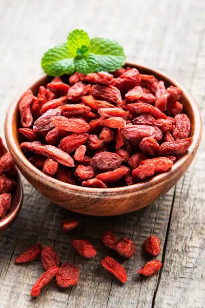 Dried goji berries in wooden bowl — traditional TCM ingredient